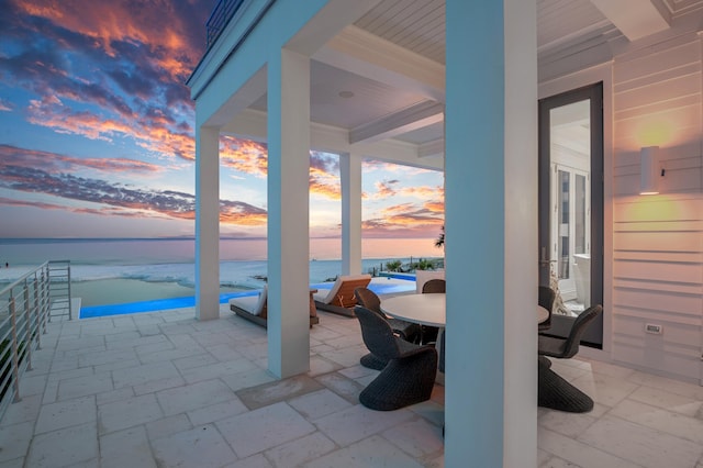 view of patio / terrace with outdoor dining space and a water view