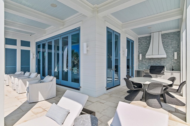 view of patio / terrace with a grill, outdoor dining area, exterior kitchen, and french doors