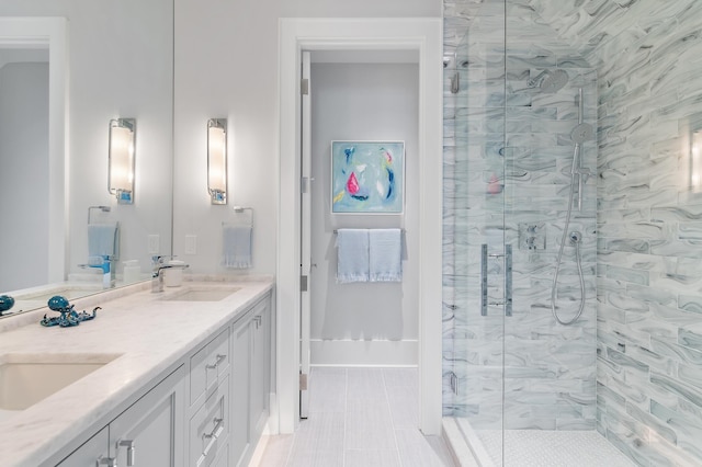 bathroom with double vanity, a sink, and a shower stall