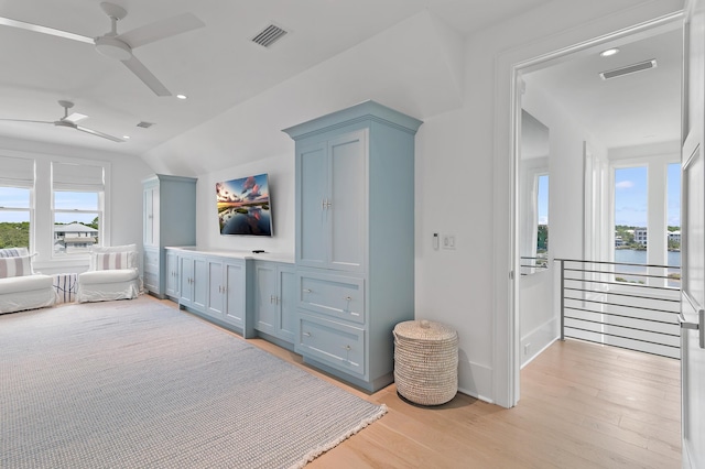 interior space featuring visible vents, ceiling fan, and light wood finished floors