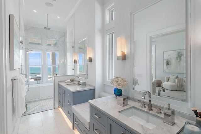 full bath featuring ornamental molding, two vanities, a sink, and a water view