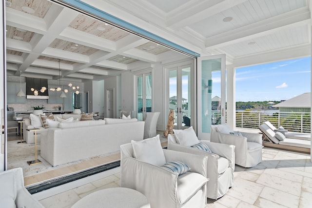 sunroom / solarium with french doors, coffered ceiling, beamed ceiling, and an inviting chandelier