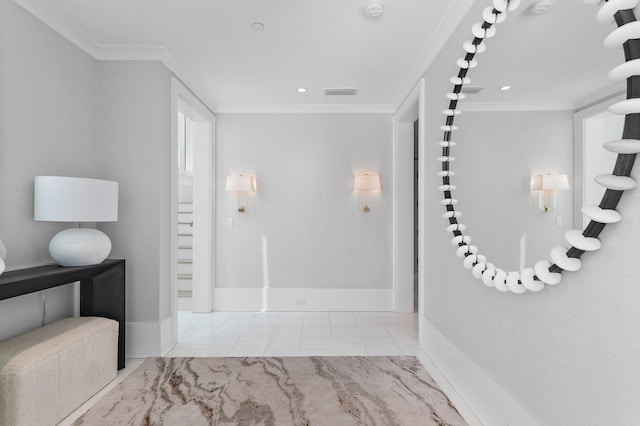 interior space with baseboards, visible vents, and ornamental molding