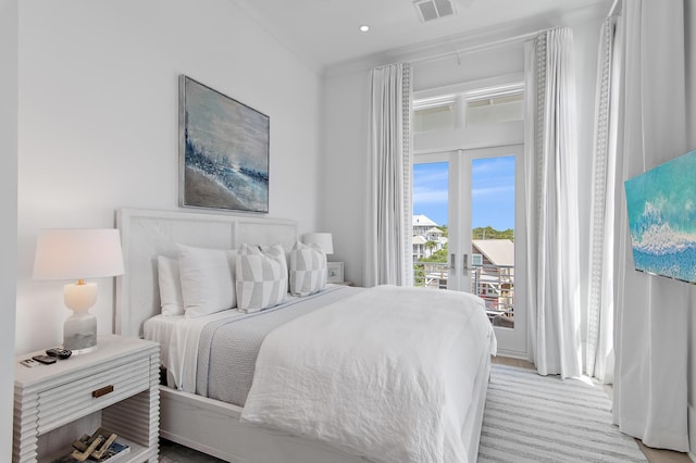 bedroom featuring light colored carpet, access to outside, french doors, and visible vents