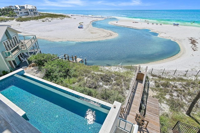 birds eye view of property with a view of the beach and a water view