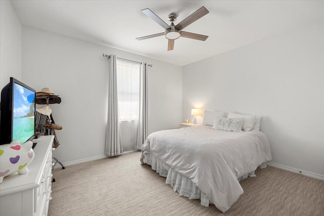 bedroom featuring ceiling fan and light carpet