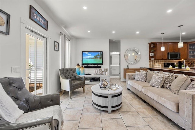 living room with light tile patterned floors and a healthy amount of sunlight