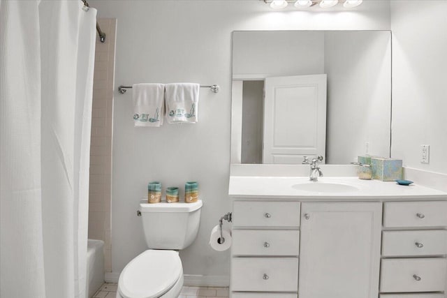 full bathroom featuring shower / bath combo with shower curtain, tile patterned floors, vanity, and toilet