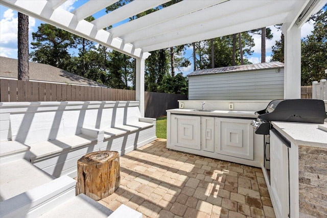 view of patio / terrace featuring a grill, a pergola, area for grilling, and sink