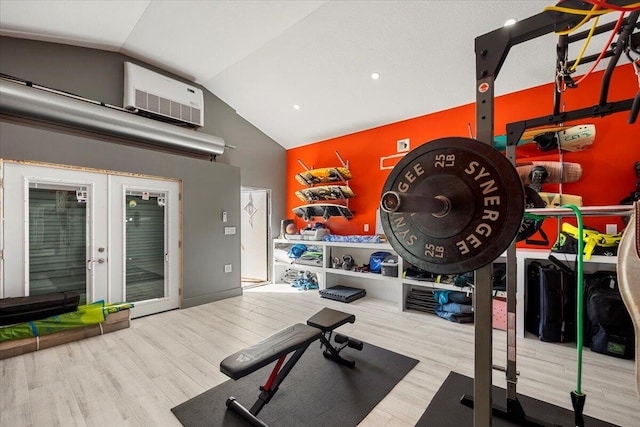 workout area with french doors, lofted ceiling, a wall mounted air conditioner, and wood-type flooring