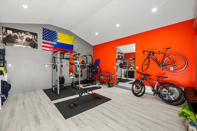 workout area featuring lofted ceiling and light hardwood / wood-style flooring