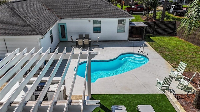 view of swimming pool featuring a patio and a lawn