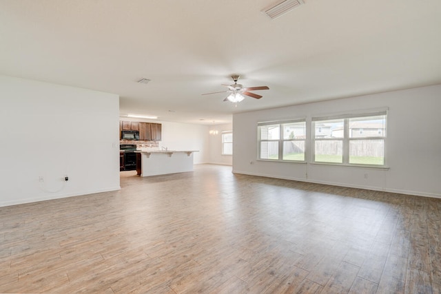 unfurnished living room featuring light hardwood / wood-style floors and ceiling fan