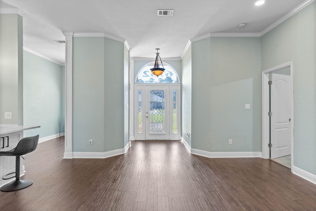 foyer featuring ornamental molding and dark hardwood / wood-style floors