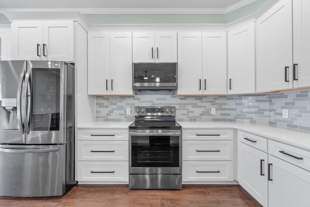 kitchen featuring appliances with stainless steel finishes, ornamental molding, decorative backsplash, and white cabinets