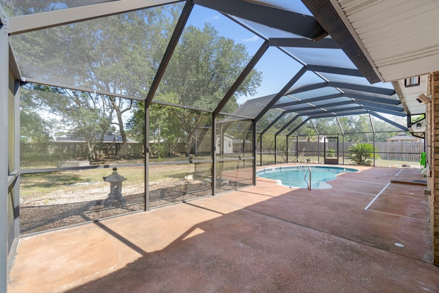 view of swimming pool featuring a patio and a lanai