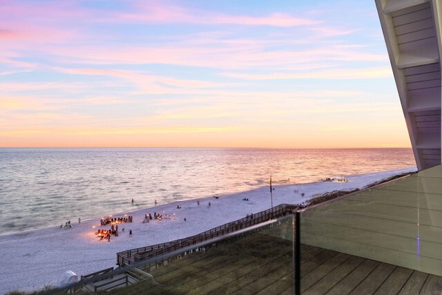 view of dock featuring a view of the beach and a water view