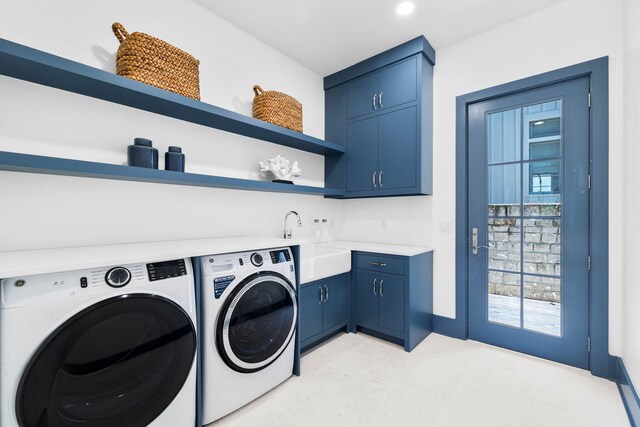 laundry area with sink, washer and dryer, and cabinets