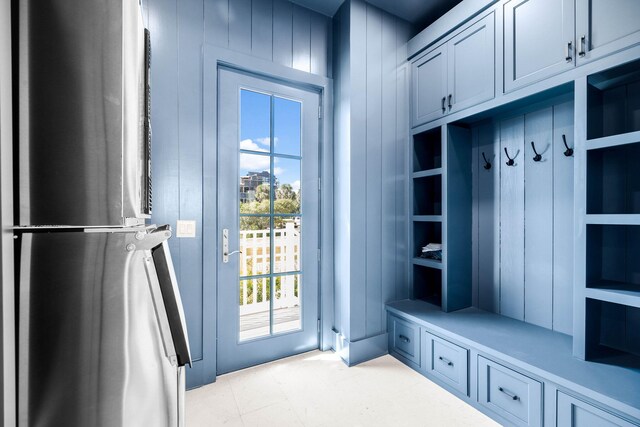 mudroom with wooden walls and plenty of natural light