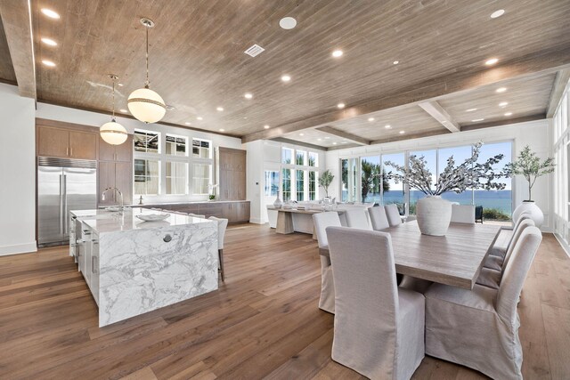 dining room featuring wood ceiling, a wealth of natural light, and hardwood / wood-style flooring