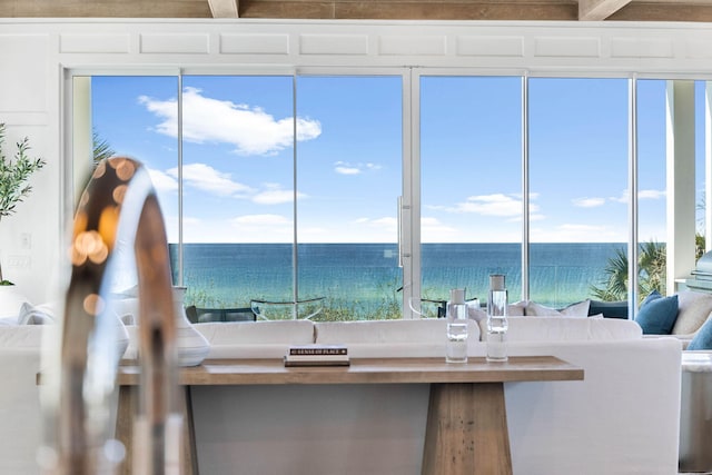 interior space featuring beam ceiling and a water view