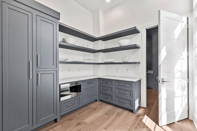 interior space with gray cabinetry and light wood-type flooring