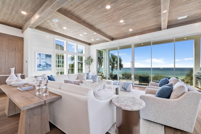 living room with wooden ceiling, a water view, hardwood / wood-style floors, and beamed ceiling