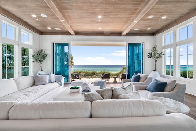 living room with wood ceiling, a water view, a healthy amount of sunlight, and hardwood / wood-style floors