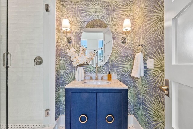 bathroom with walk in shower and vanity