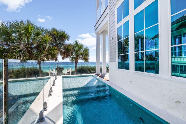 view of pool with a water view