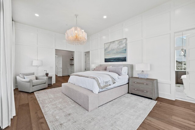 bedroom featuring a notable chandelier and hardwood / wood-style floors