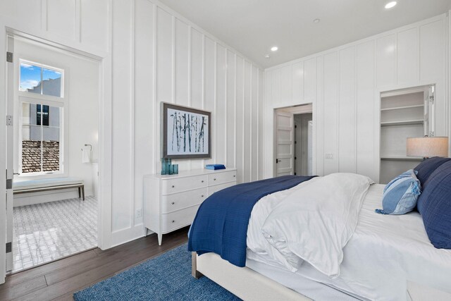 bedroom featuring multiple windows and dark hardwood / wood-style floors