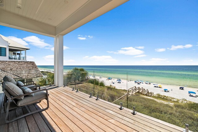 wooden terrace with a water view and a beach view