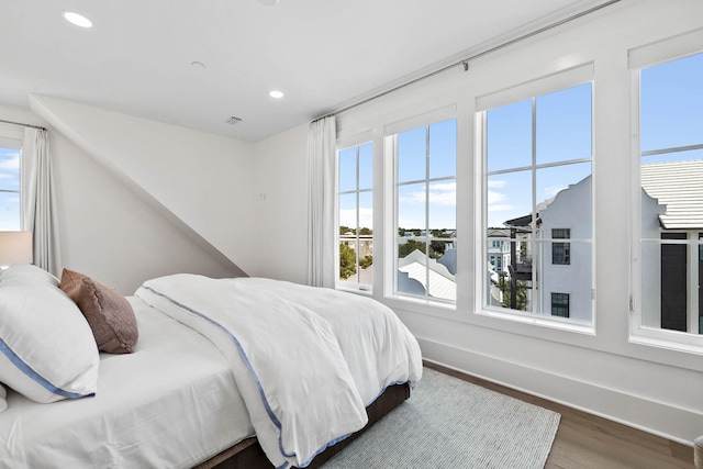 bedroom with dark hardwood / wood-style flooring