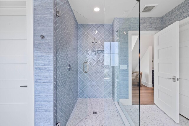 bathroom featuring hardwood / wood-style floors and an enclosed shower