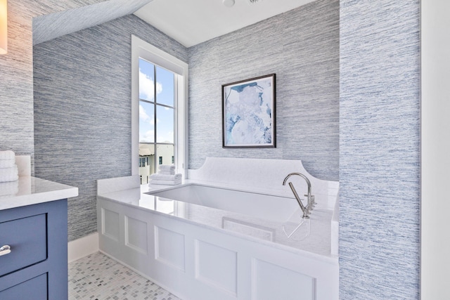 bathroom with vanity and a tub