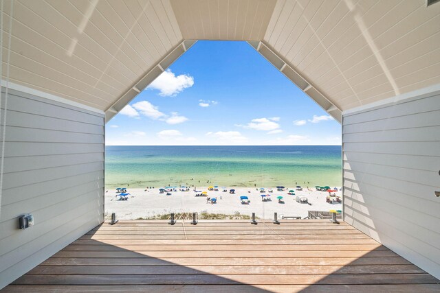 deck featuring a view of the beach and a water view