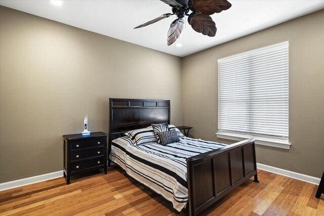 bedroom with ceiling fan and light wood-type flooring