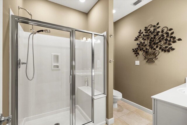 bathroom with vanity, a shower with shower door, toilet, and tile patterned floors