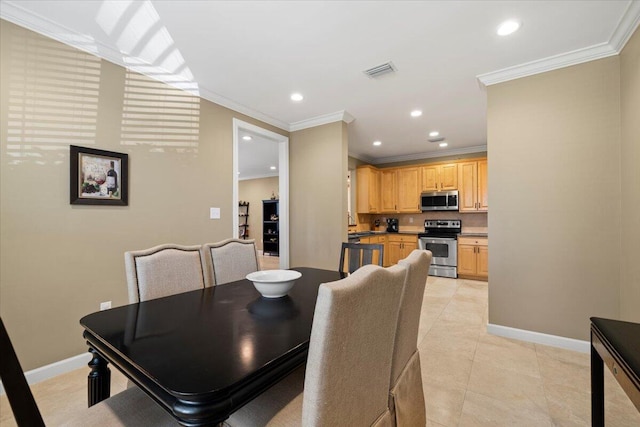 tiled dining room featuring ornamental molding