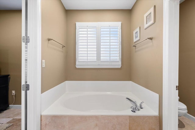 bathroom with tiled bath and toilet