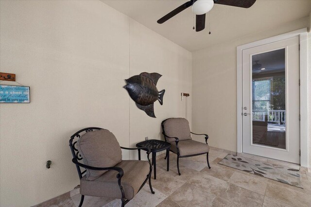 living area featuring ceiling fan