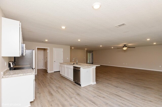 kitchen with white cabinets, stainless steel appliances, ceiling fan, light hardwood / wood-style flooring, and sink