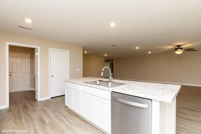 kitchen with light wood-type flooring, sink, white cabinets, a center island with sink, and stainless steel dishwasher