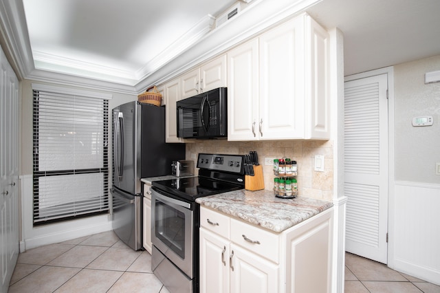 kitchen with stainless steel electric stove, backsplash, ornamental molding, light tile patterned floors, and light stone counters