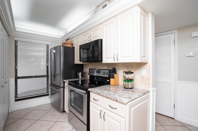 114 Main Sail Dr Unit 137, Miramar Beach, FL 32550 - kitchen with stainless steel appliances, light tile patterned floors, crown molding, white cabinets, and backsplash