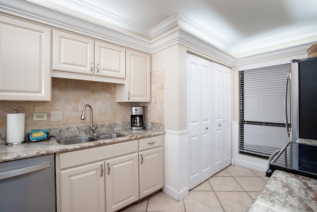 kitchen featuring light tile patterned floors, appliances with stainless steel finishes, light stone countertops, ornamental molding, and sink