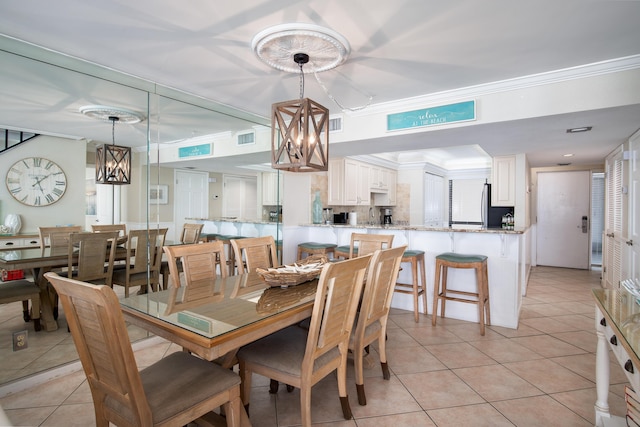 114 Main Sail Dr Unit 137, Miramar Beach, FL 32550 - dining area featuring a chandelier, light tile patterned floors, and ornamental molding