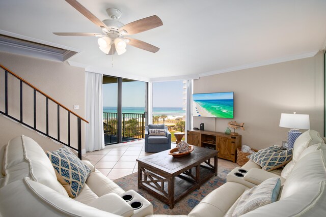 114 Main Sail Dr Unit 137, Miramar Beach, FL 32550 - living area with ornamental molding, a wall of windows, ceiling fan, tile patterned flooring, and stairs