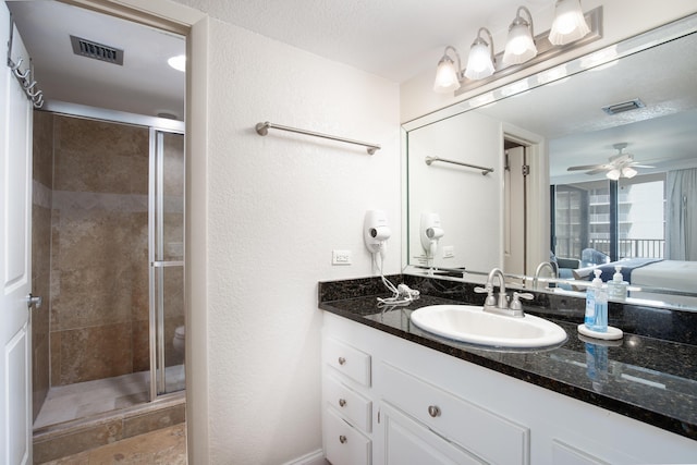 114 Main Sail Dr Unit 137, Miramar Beach, FL 32550 - ensuite bathroom featuring a shower stall, vanity, a textured wall, and a ceiling fan